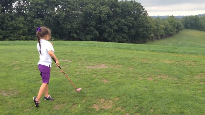 girl playing golf